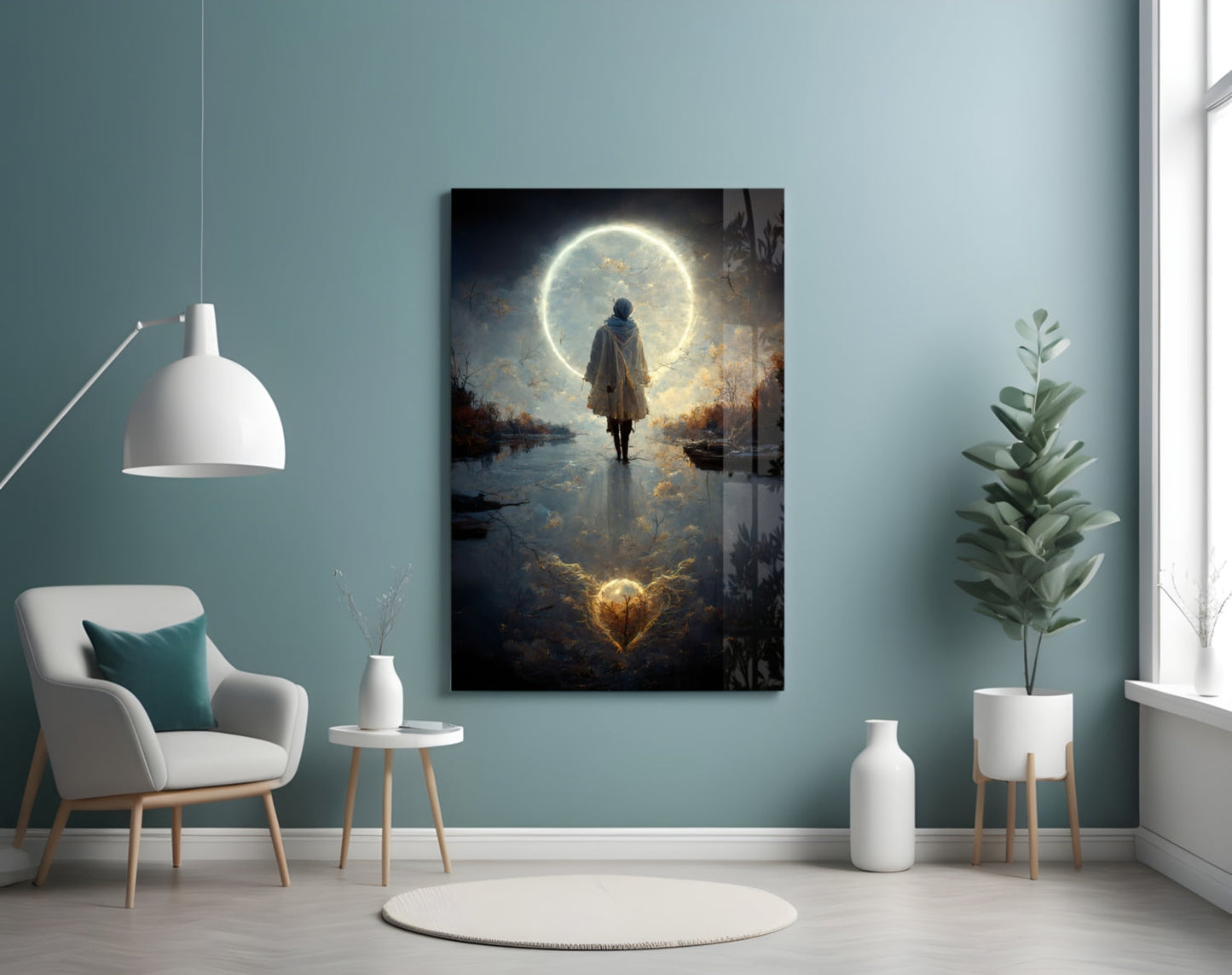 Glass wall art panel displaying a figure standing before a glowing moon reflected in water, mounted in minimalist room with teal walls.