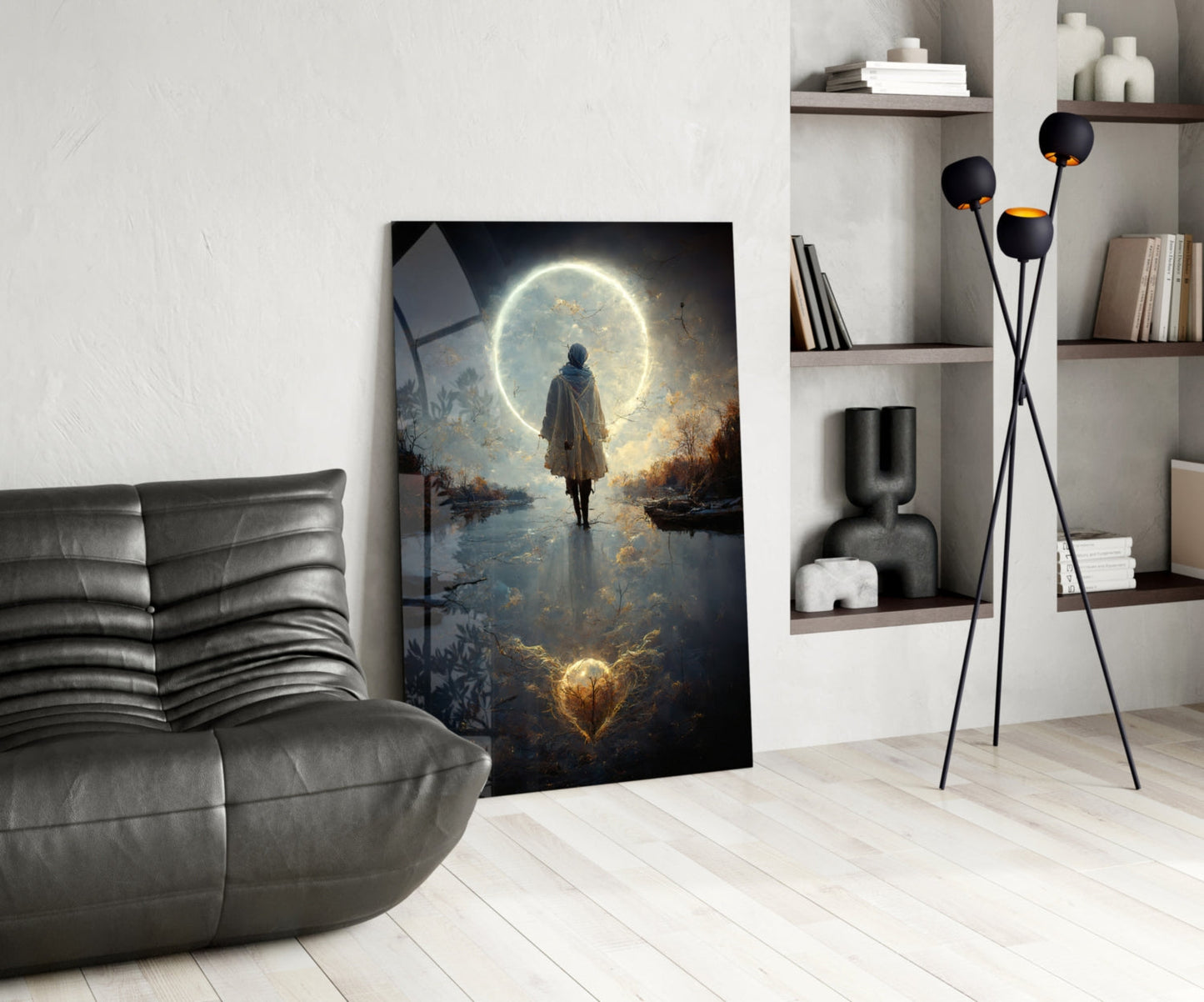 Modern living room displaying a vertical glass wall art panel featuring a robed figure standing before a luminous moon reflected in water.