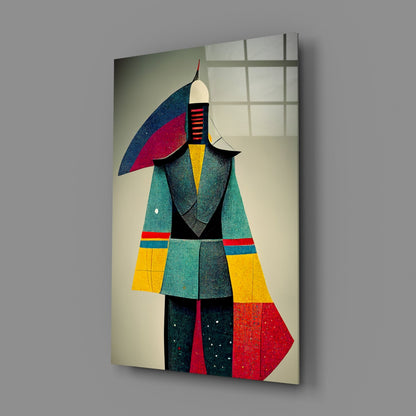 Geometric glass art panel featuring a stylized figure in turquoise, yellow, red, and navy colors displayed at an angle against gray wall.
