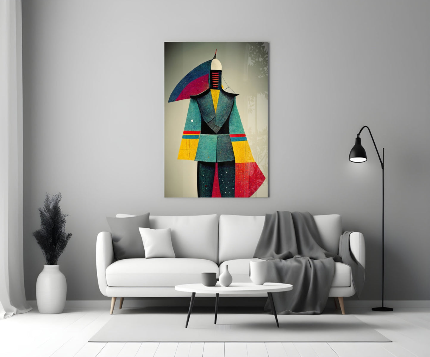Colorful abstract glass art depicting a geometric figure in teal, red, yellow, and blue displayed above a white sofa in a modern living room.