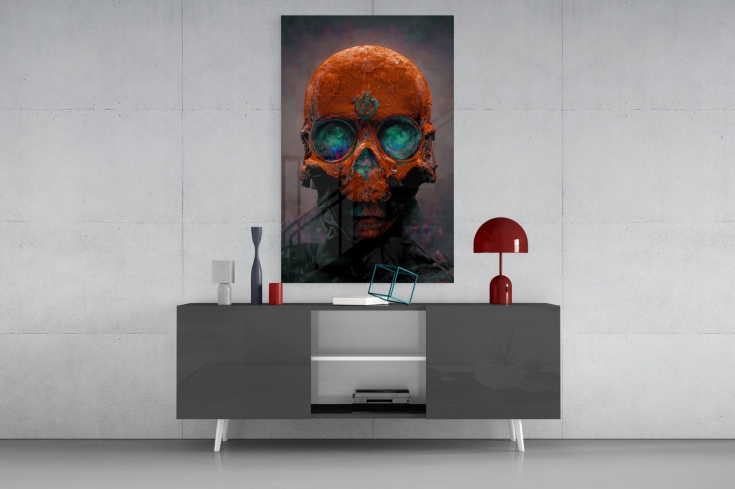 Orange and teal skull glass art with glowing eyes displayed on gray media console with red lamp and decorative objects.