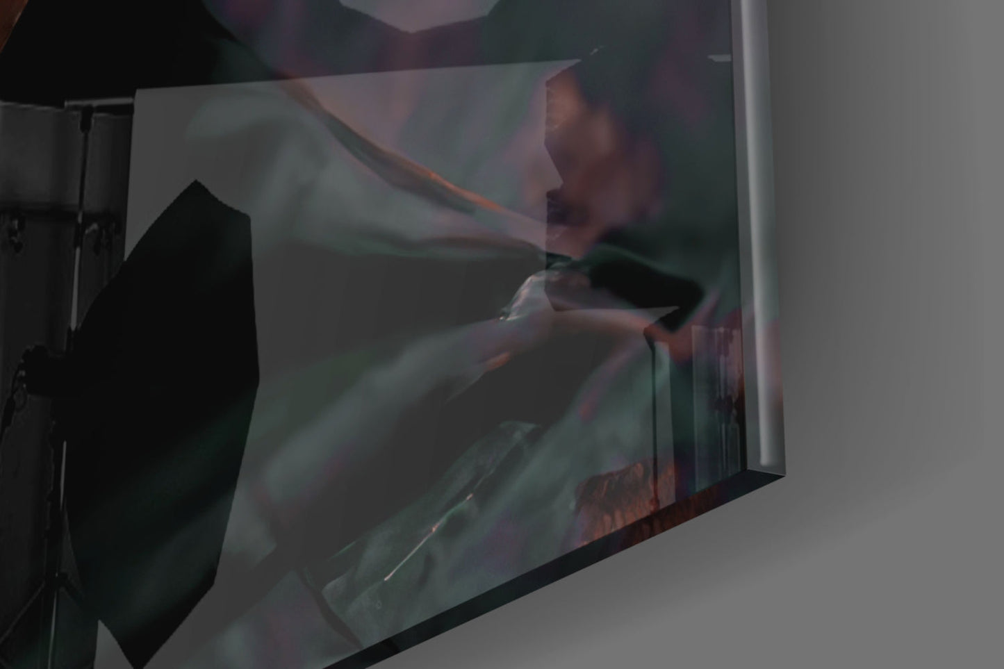 Angled view of translucent skull glass art mounted on white wall, displaying green and amber tones through the glass.