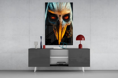 Dramatic glass wall art featuring a close-up owl face with glowing red eyes and golden beak displayed above a modern gray console table in a minimalist interior setting.