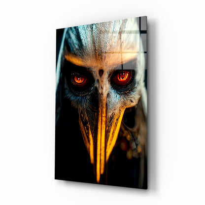 Close-up angled view of glass wall art showing owl face with glowing red eyes and golden yellow beak against dark background.