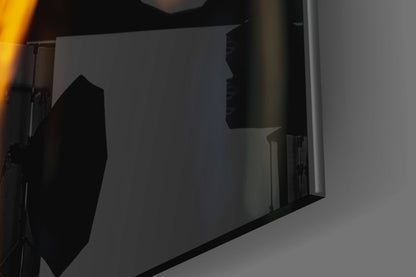 Black silhouette profile artwork displayed on illuminated white wall panel with architectural staircase visible in background.