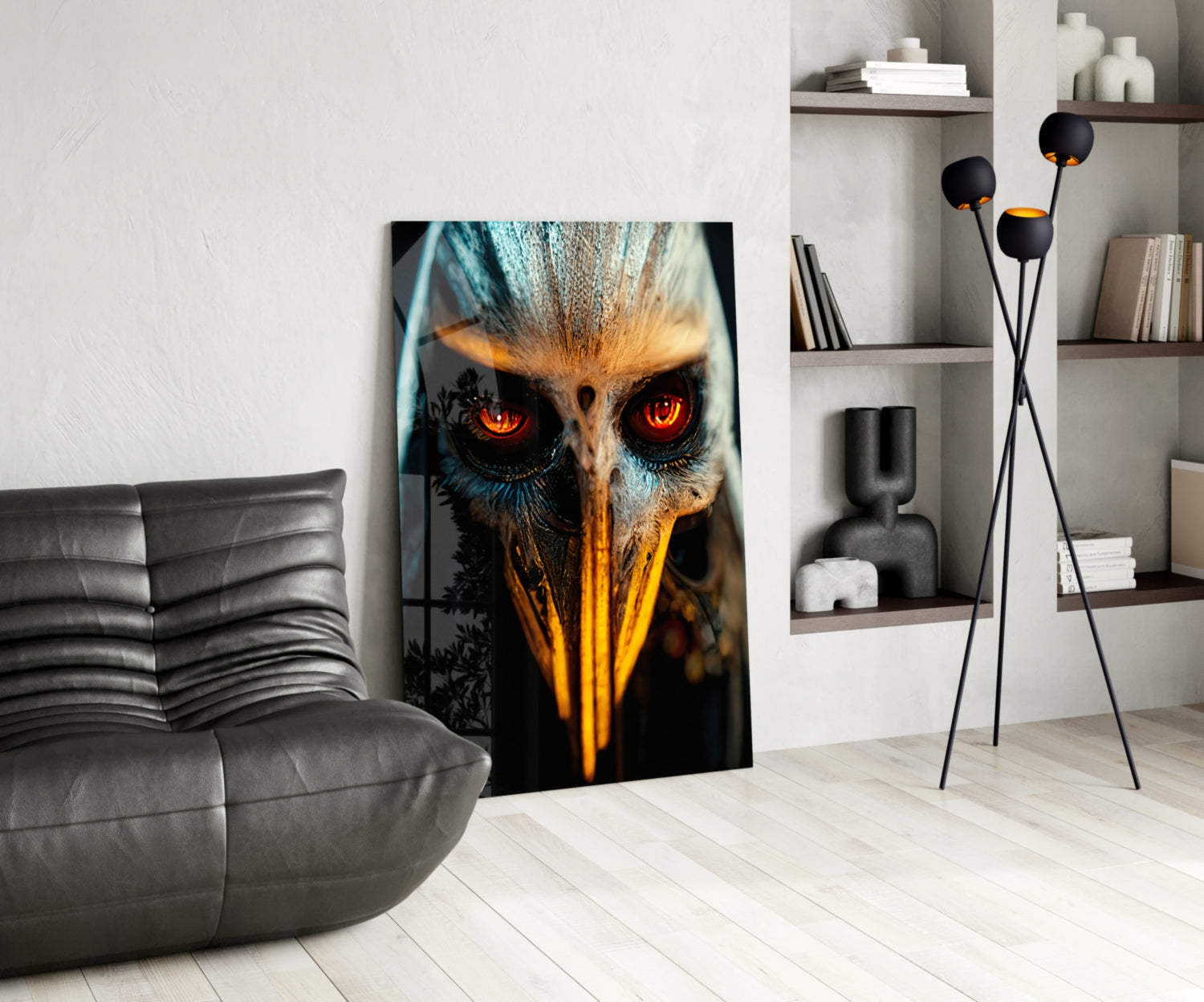 Modern living room interior with glowing red-eyed owl glass art leaning against white wall beside gray sofa.
