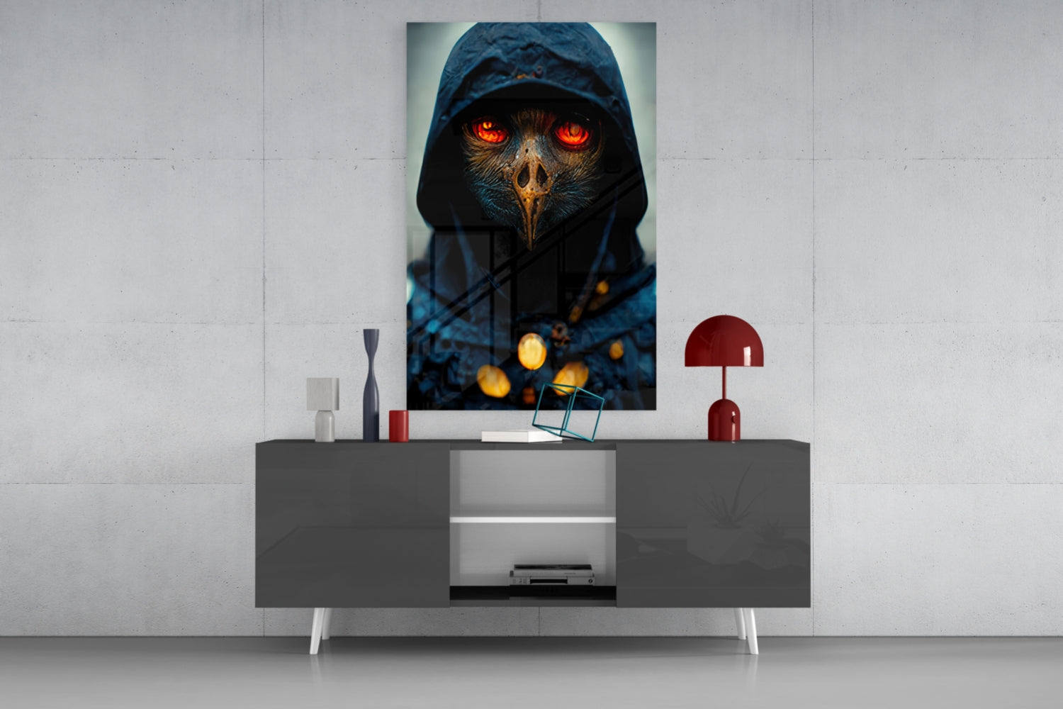 Glass art print of a hooded figure with glowing red eyes displayed on a white wall above a gray console table with decorative objects.