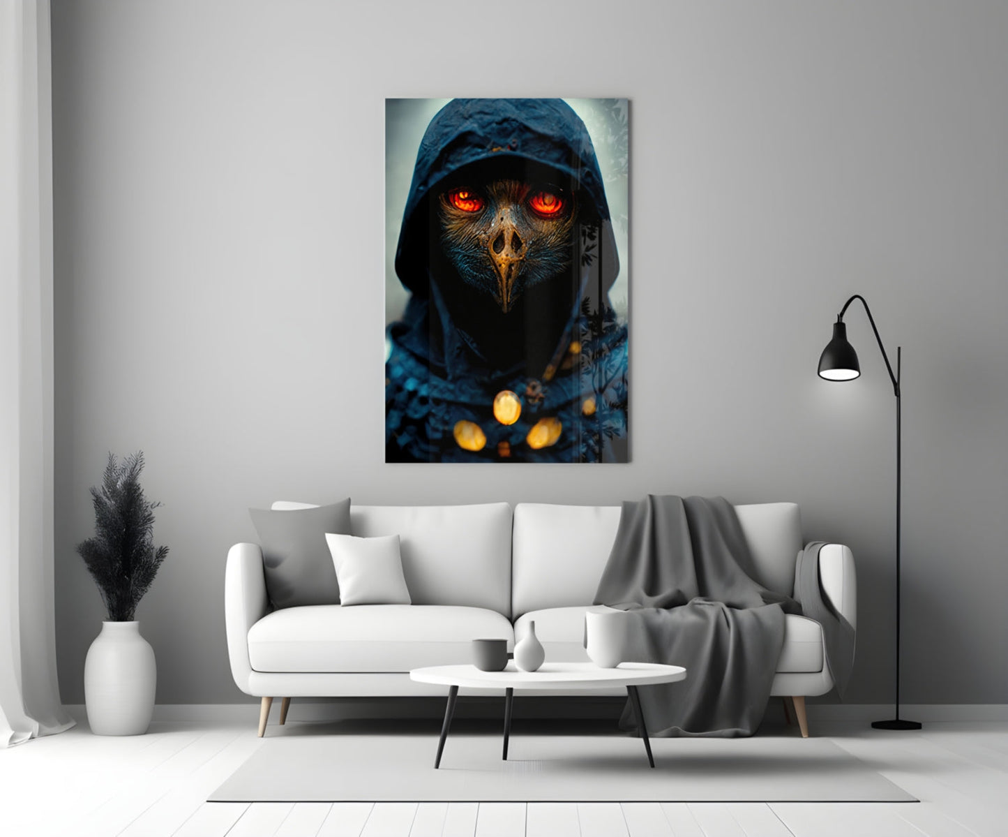 Fiery Eyes Glass Art depicting a hooded figure with glowing red eyes and golden chest ornaments mounted above a white sofa in a modern living room setting.