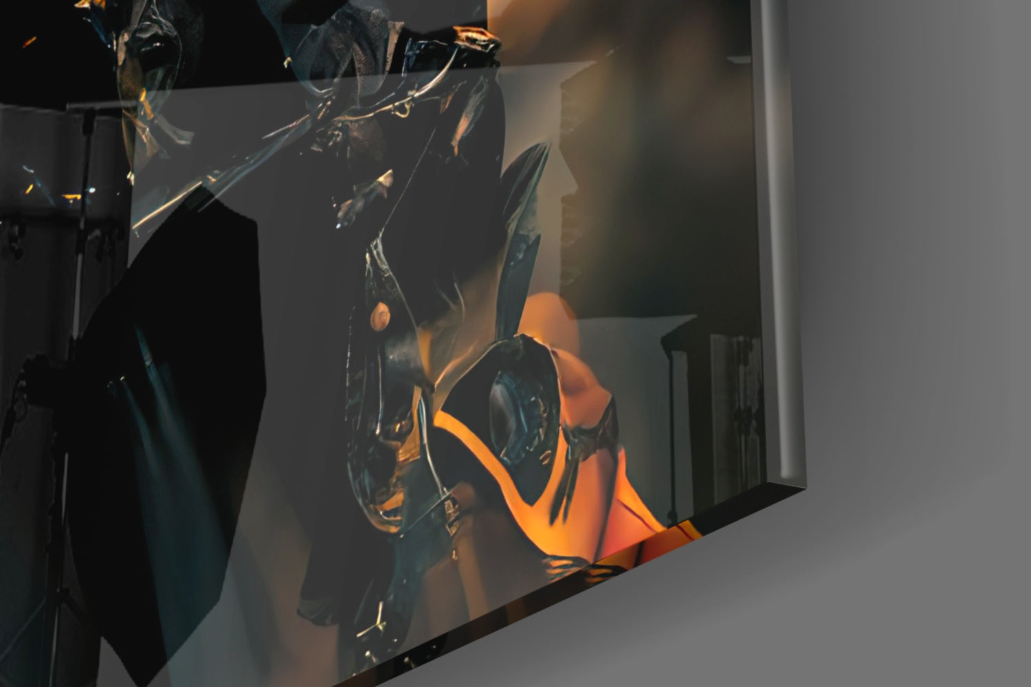 Close-up of black glass art sculpture with orange and gold accents illuminated against white gallery wall.