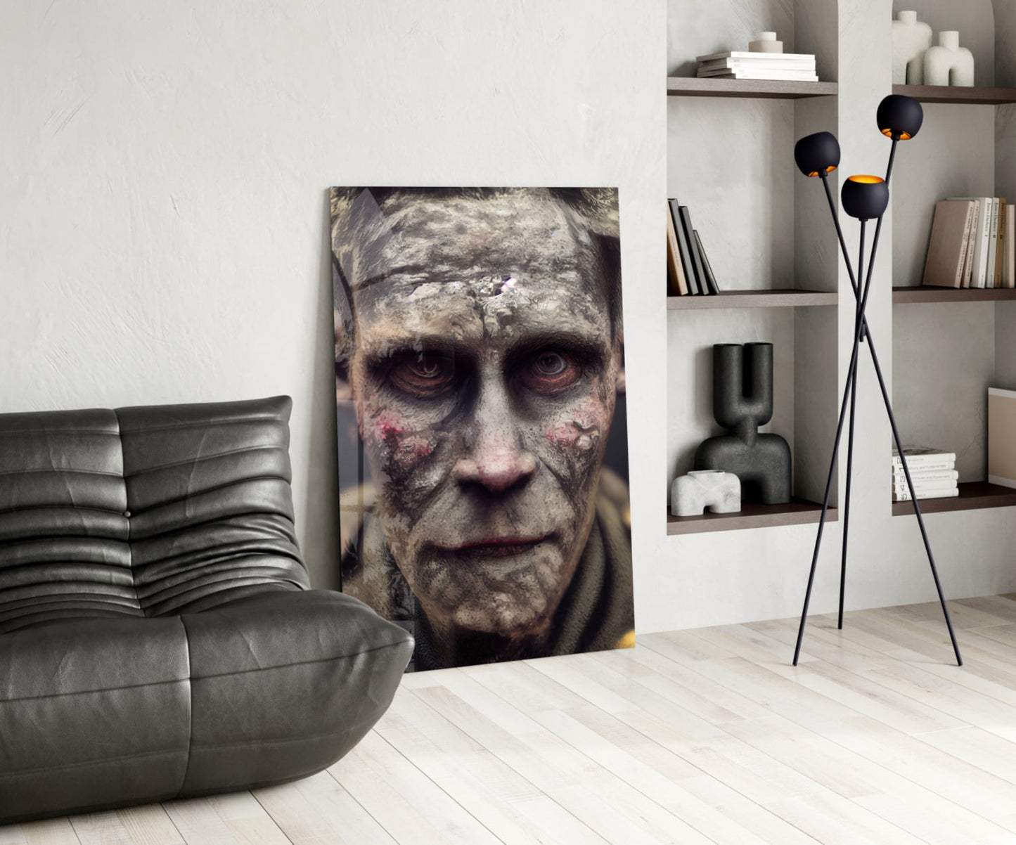 Decayed face glass art displayed vertically in modern living room with gray leather chair, black floor lamp, and white shelving unit.