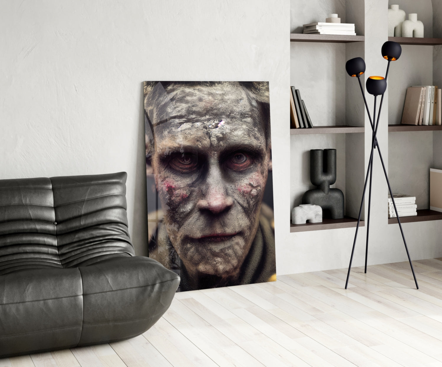 Decayed face glass art displayed vertically in modern living room with gray leather chair, black floor lamp, and white shelving unit.