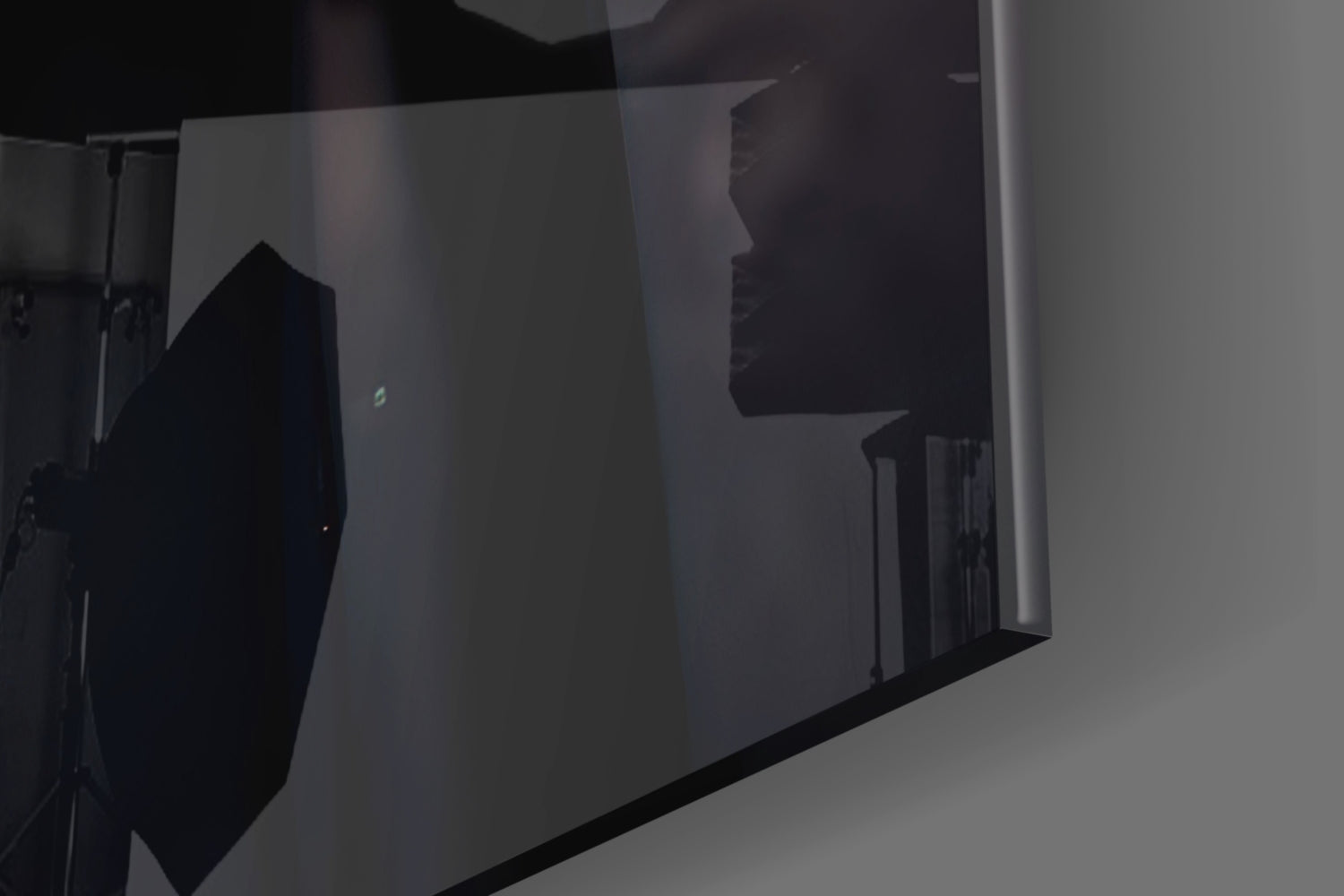 Silhouettes of two people visible through frosted glass panels with black frame dividers in interior space.