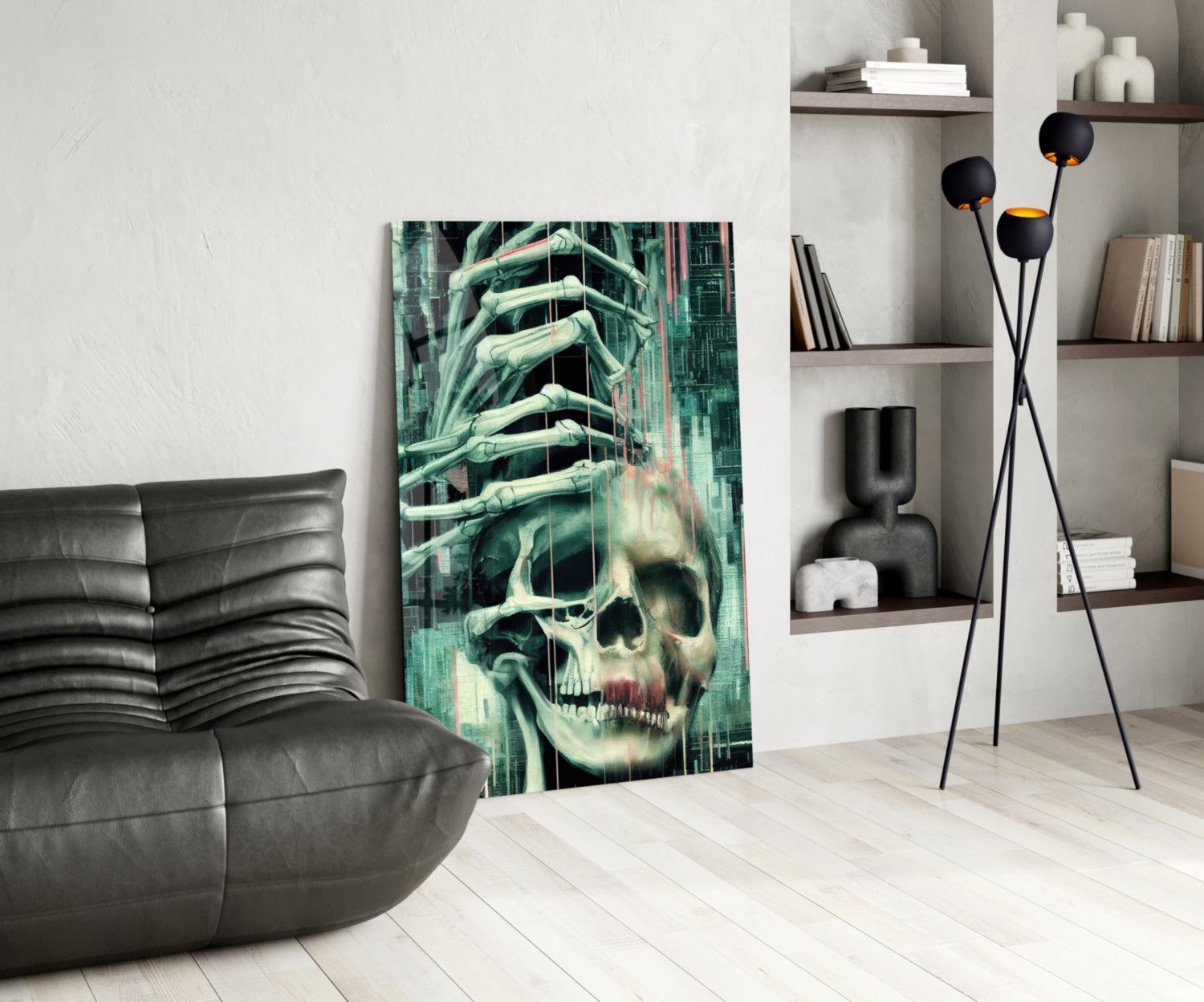 Glass art depicting skull with skeletal hand overlay in green and teal tones displayed in modern living room setting.