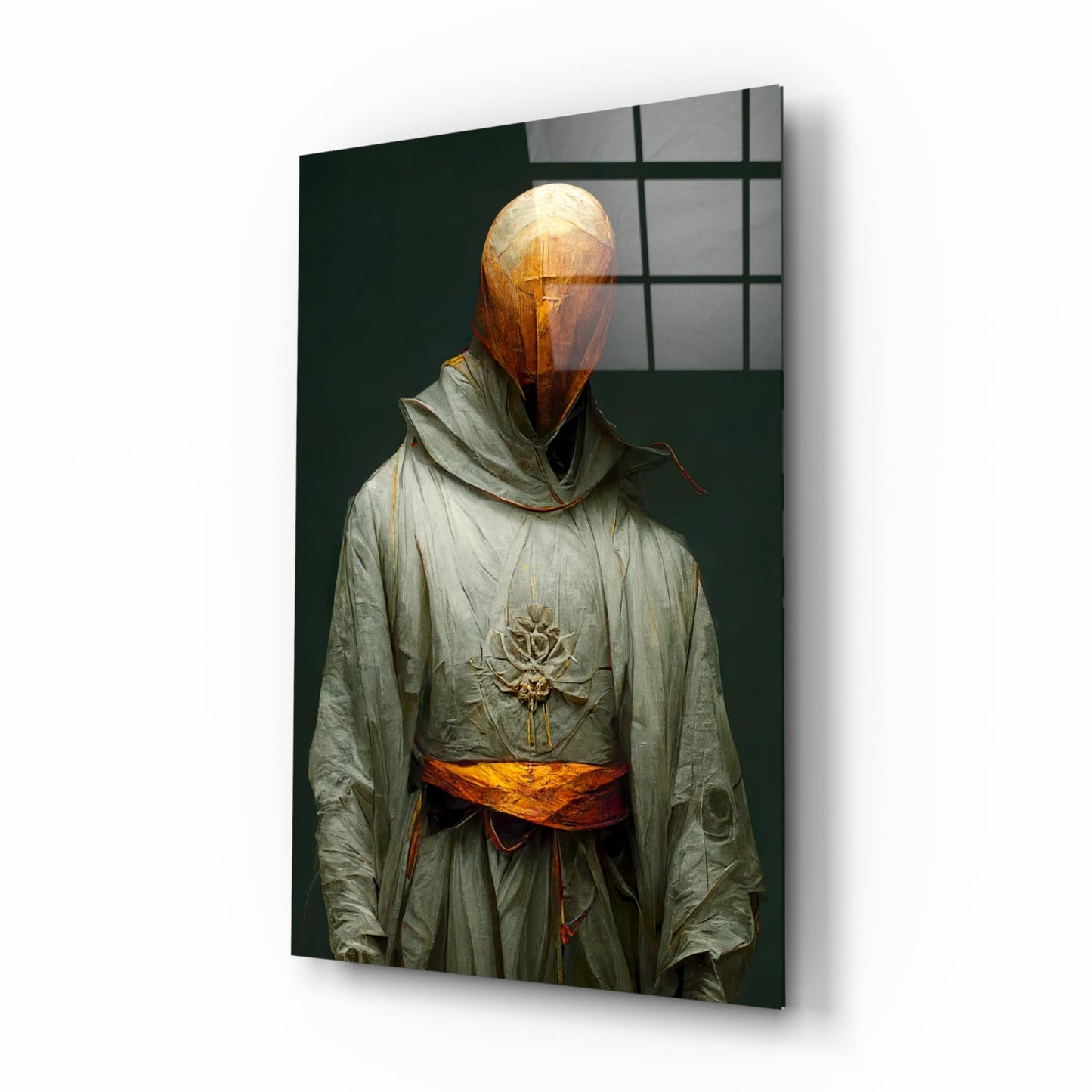 Angled view of glass art panel showing robed figure with glowing amber head, embroidered lotus chest motif, and orange sash against dark green background.