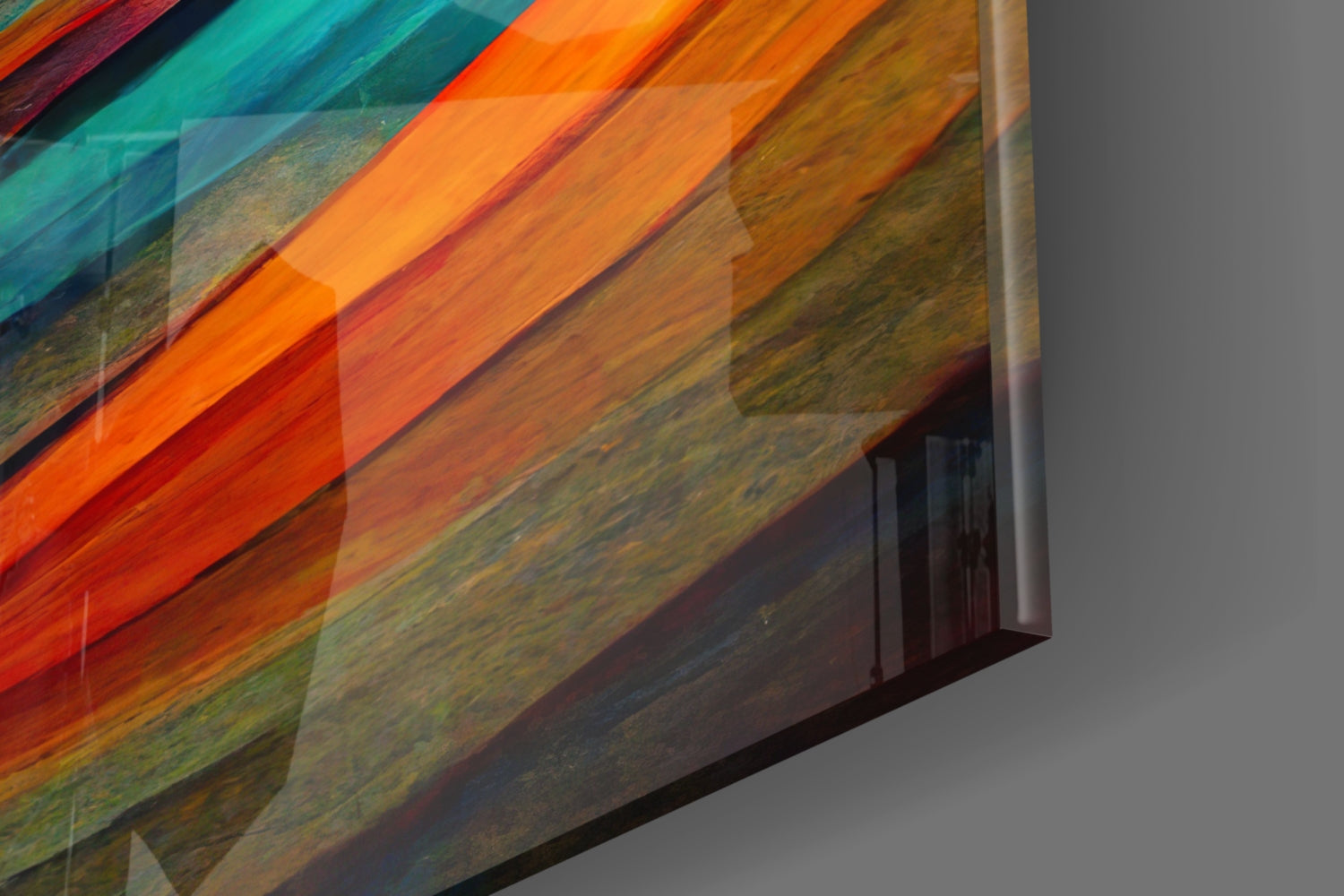 Angled close-up of layered glass art piece displaying vibrant orange, red, teal, and natural wood tones with diagonal composition.