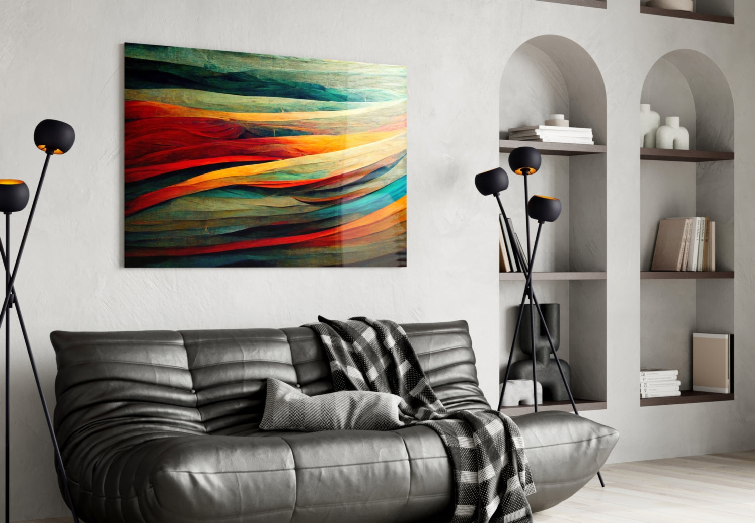 Horizontal glass art panel with flowing red, orange, teal, and cream striped design hung above black leather sofa in modern living room interior.