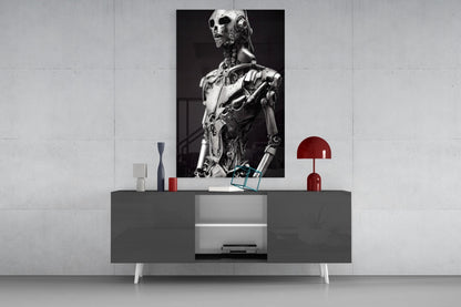 Modern minimalist interior with gray console table displaying red lamp and decorative items beneath black and white robotic figure artwork.