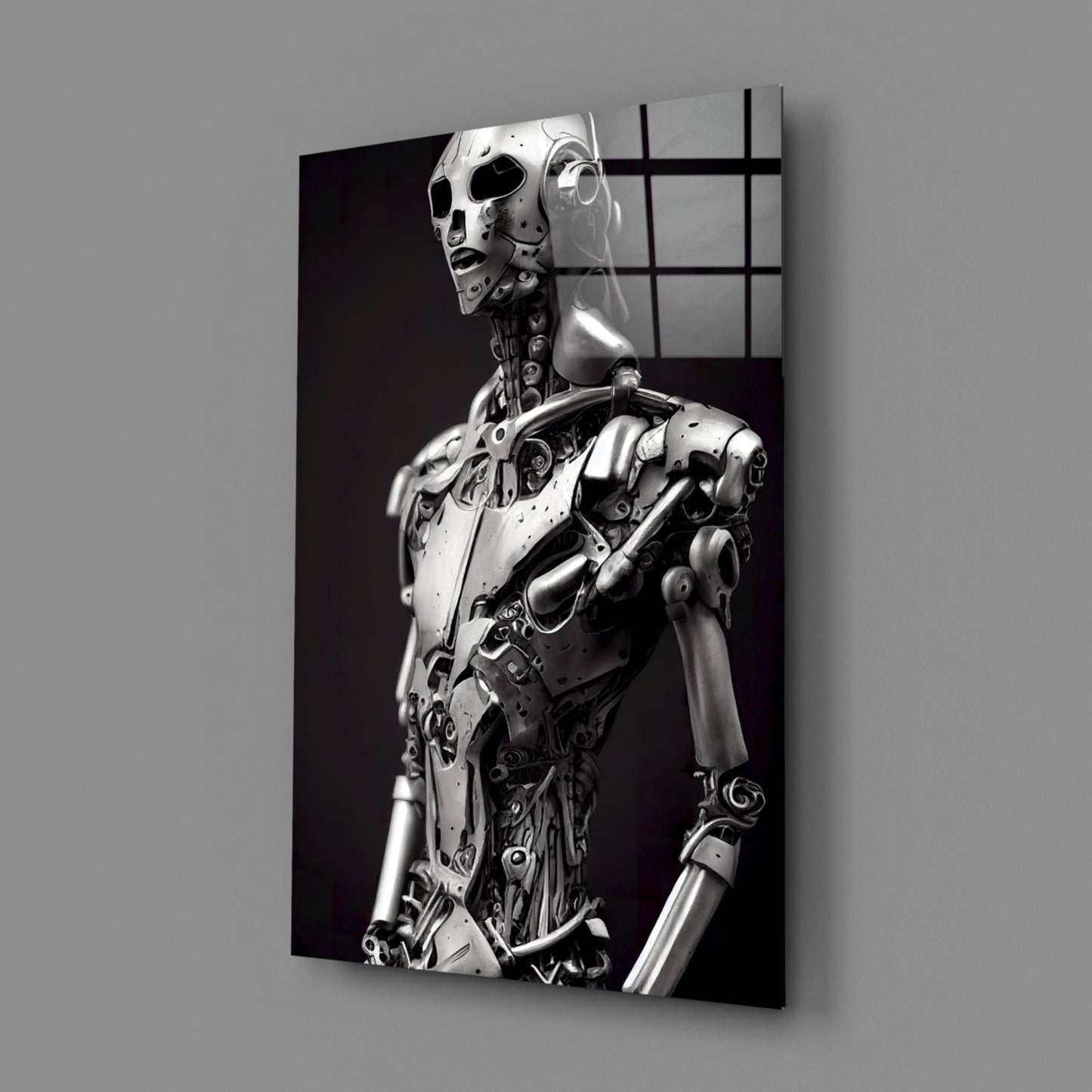 Monochromatic glass art panel displaying a metallic humanoid robot figure in profile against a dark background, viewed at an angle.