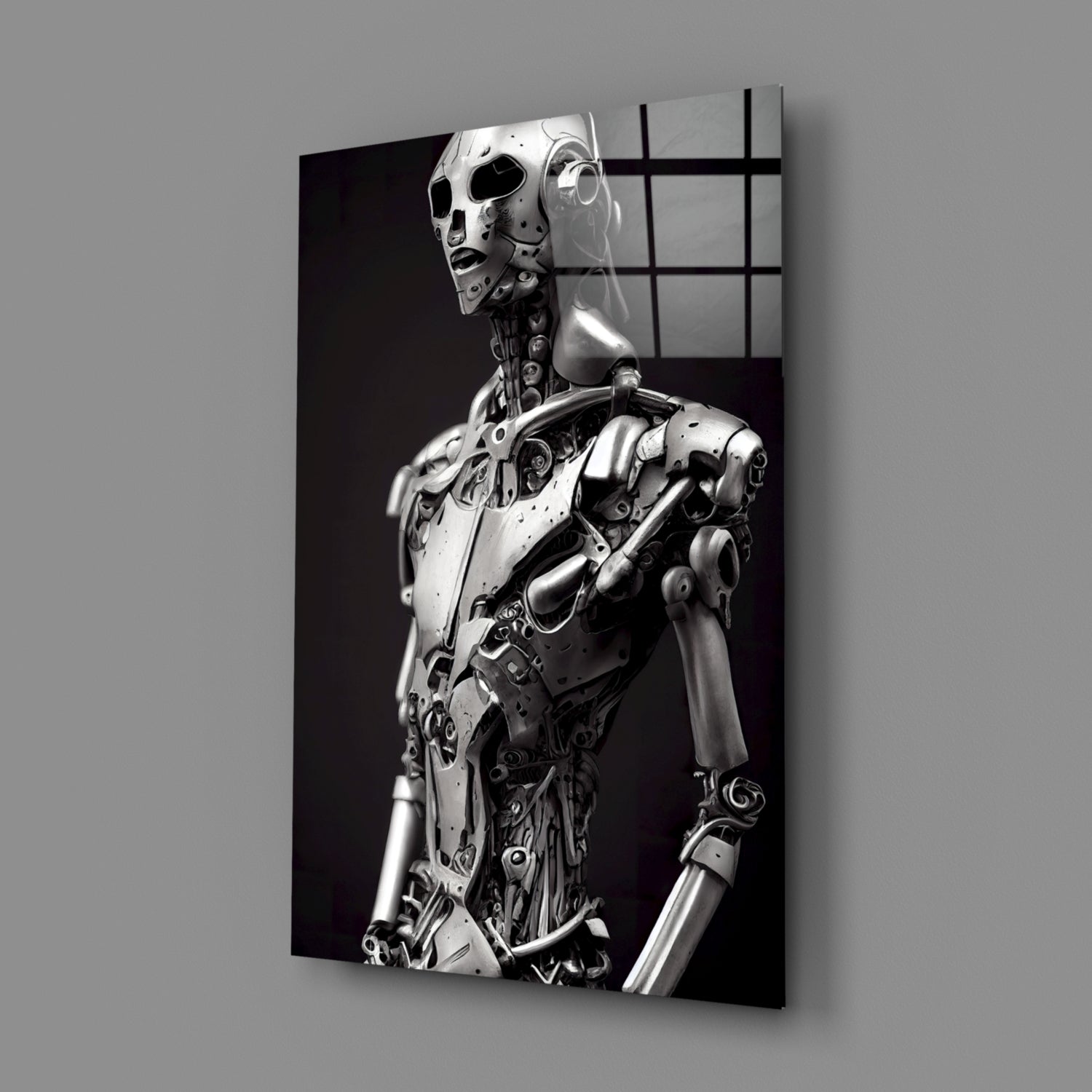 Monochromatic glass art panel displaying a metallic humanoid robot figure in profile against a dark background, viewed at an angle.