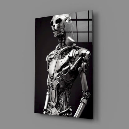 Monochromatic glass art panel displaying a metallic humanoid robot figure in profile against a dark background, viewed at an angle.