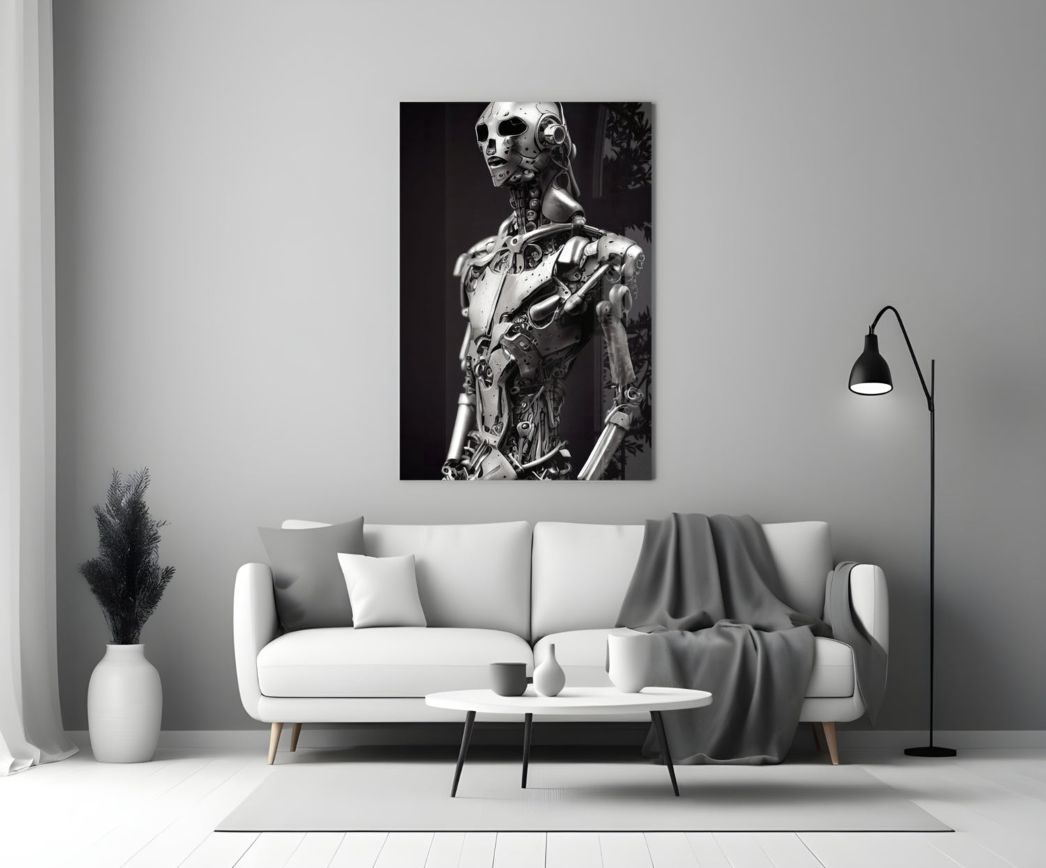 Monochromatic glass art depicting a humanoid robot figure with mechanical details displayed on a living room wall above a white sofa.