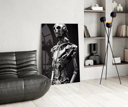 Modern living room interior featuring a monochromatic robot portrait artwork leaning against white wall beside gray leather sofa.