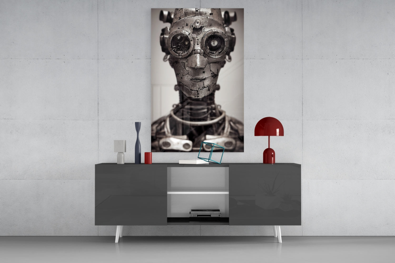 Steampunk mechanical head portrait with brass goggles displayed on wall above modern gray console table with red lamp and decorative objects.