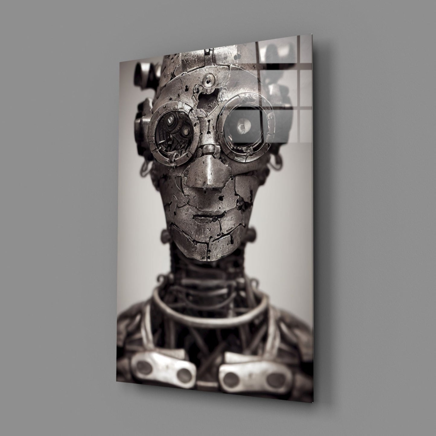 Metallic steampunk robot head with large gear eyes on gray glass wall art panel, angled perspective view.