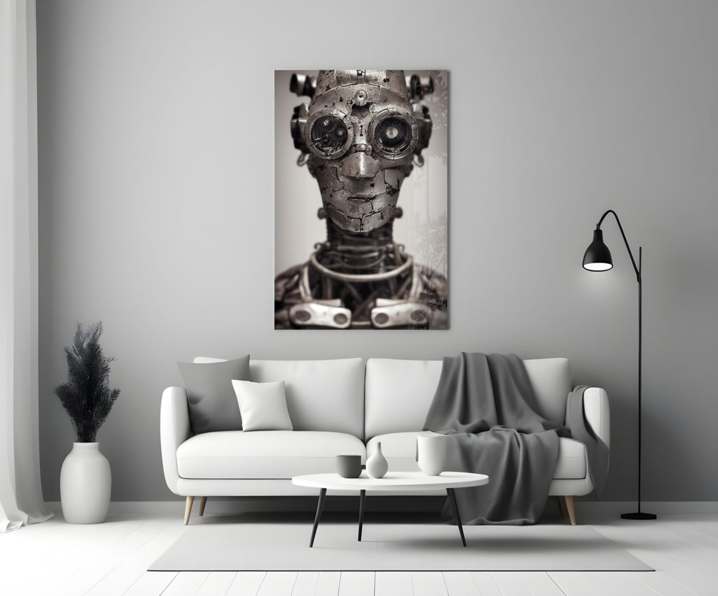 Monochromatic glass wall art depicting a mechanical humanoid head with gear eyes and metal plating, displayed above a white sofa in a minimalist interior.