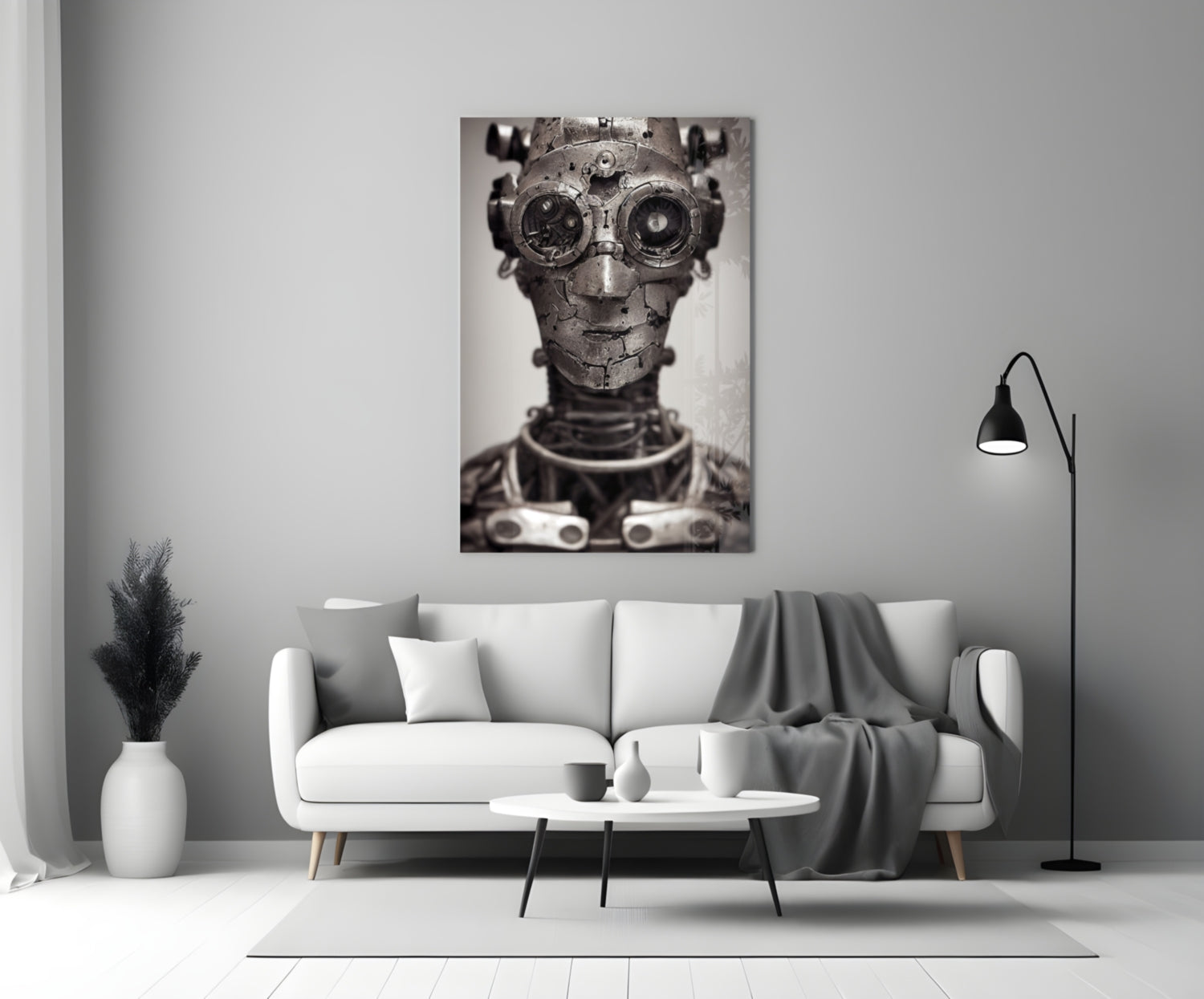 Monochromatic glass wall art depicting a mechanical humanoid head with gear eyes and metal plating, displayed above a white sofa in a minimalist interior.
