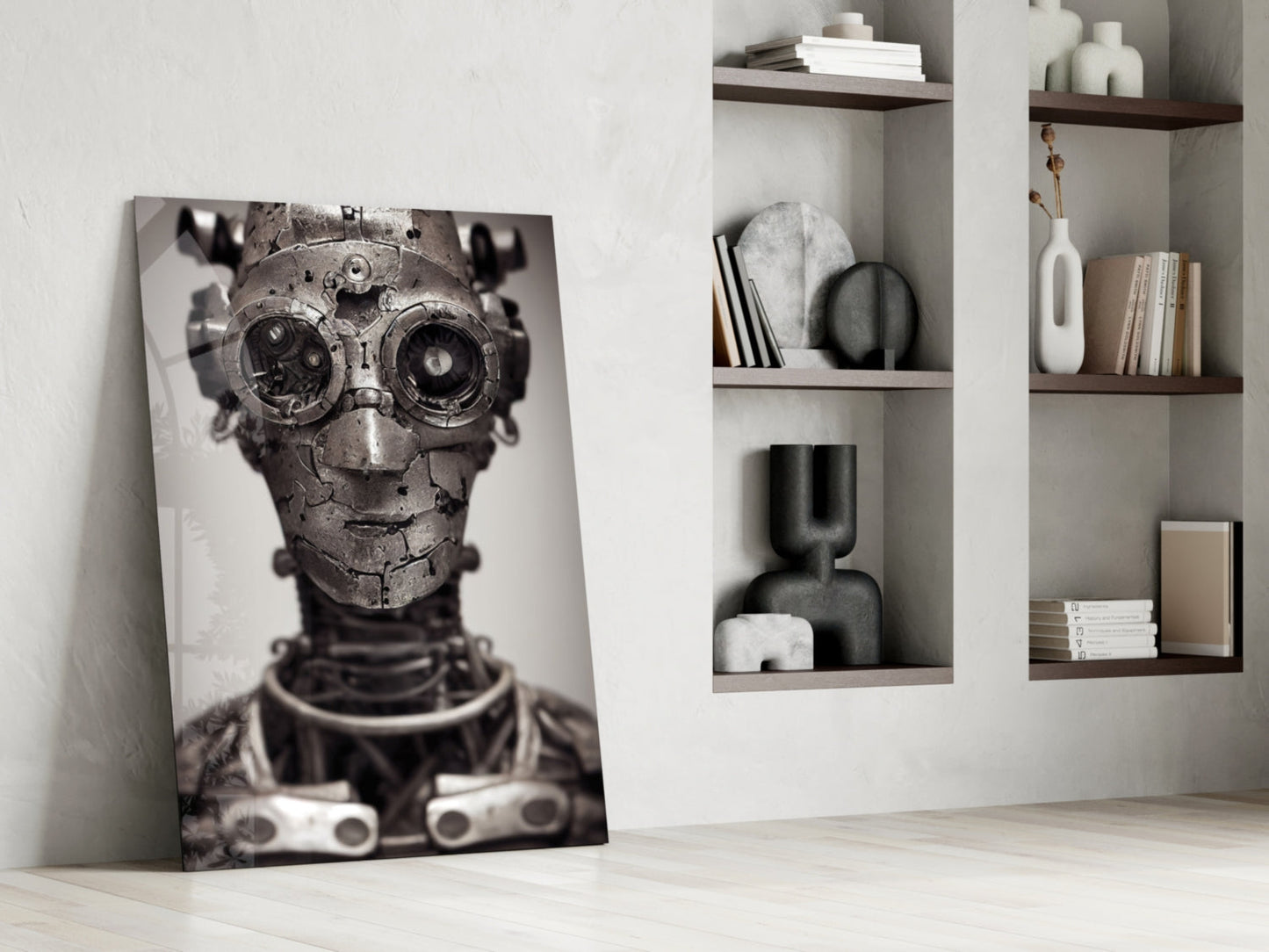 Black and white glass wall art depicting a mechanical skull with gear eyes, leaning against white wall beside floating shelves with decorative objects.
