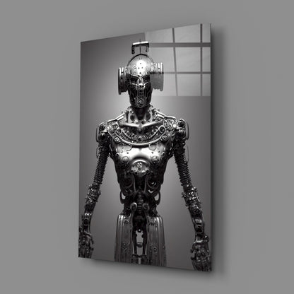 Black and white glass art print of an ornate metallic humanoid robot figure standing against a plain background with grid-patterned window reflections.