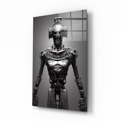Black and white photograph of an ornate mechanical humanoid figure with elaborate metallic detailing, displayed on glass wall art with gridded window reflection.