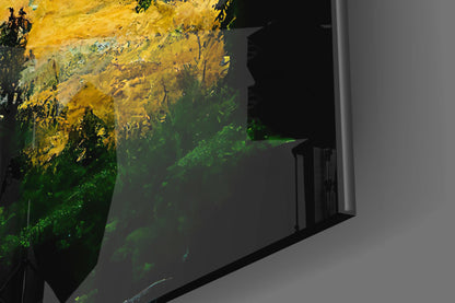 Glass art panel with yellow and green layered colors displayed on white wall, angled perspective view.