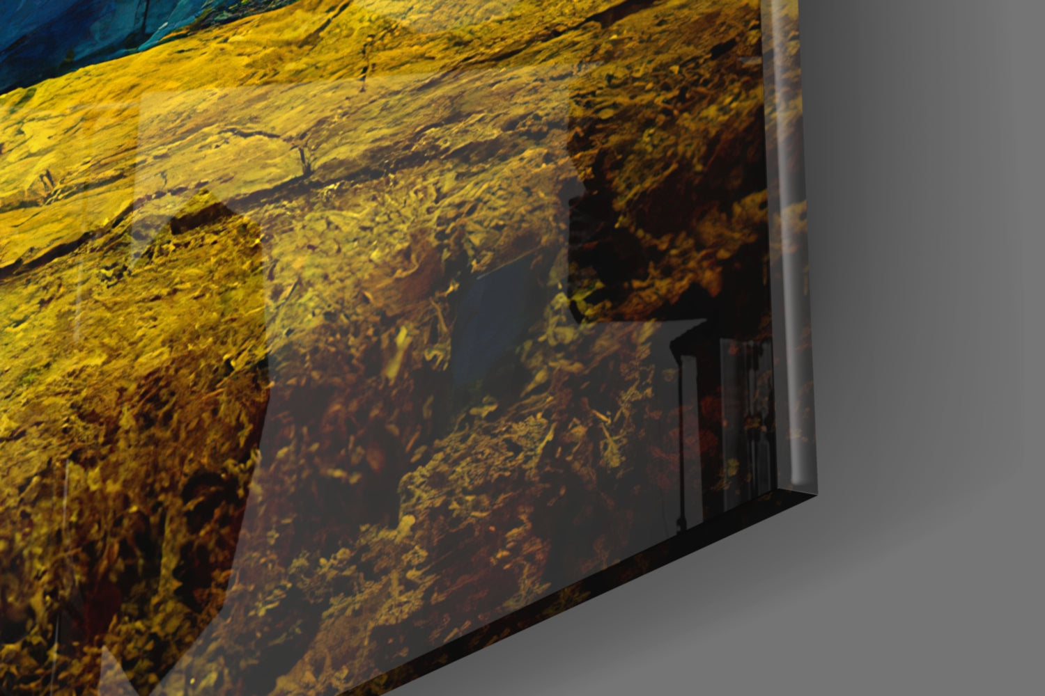 Close-up angled view of Dancing Sky Glass Art showing yellow and dark brown textured glass surface with blue tones visible at top edge.