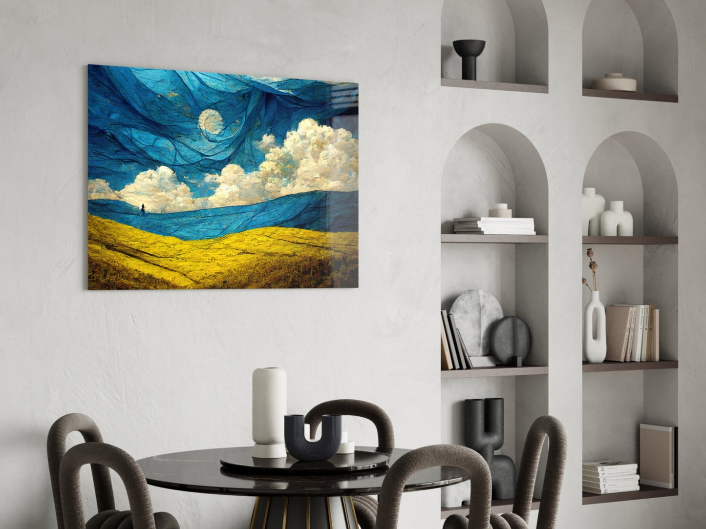 Dancing Sky Glass Art hanging on white wall above black round dining table with gray chairs and built-in shelving.