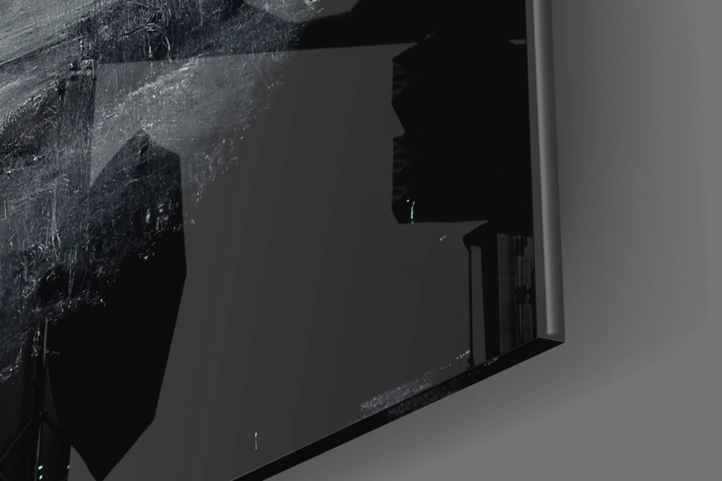 Close-up detail of textured black glass surface with scratched, weathered patterns against neutral background, shown at angled perspective.