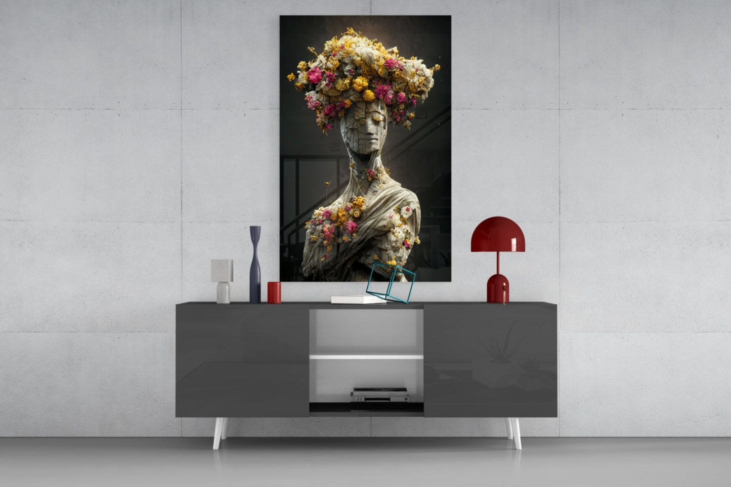 Stone statue adorned with colorful flowers displayed above modern gray media console with red accents.
