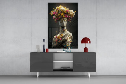Stone statue adorned with colorful flowers displayed above modern gray media console with red accents.