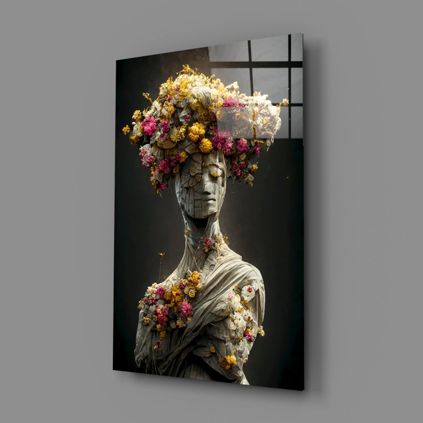 Stone sculptural bust adorned with dried pink, yellow, and white flowers against dark background, displayed as angled wall-mounted glass art panel.