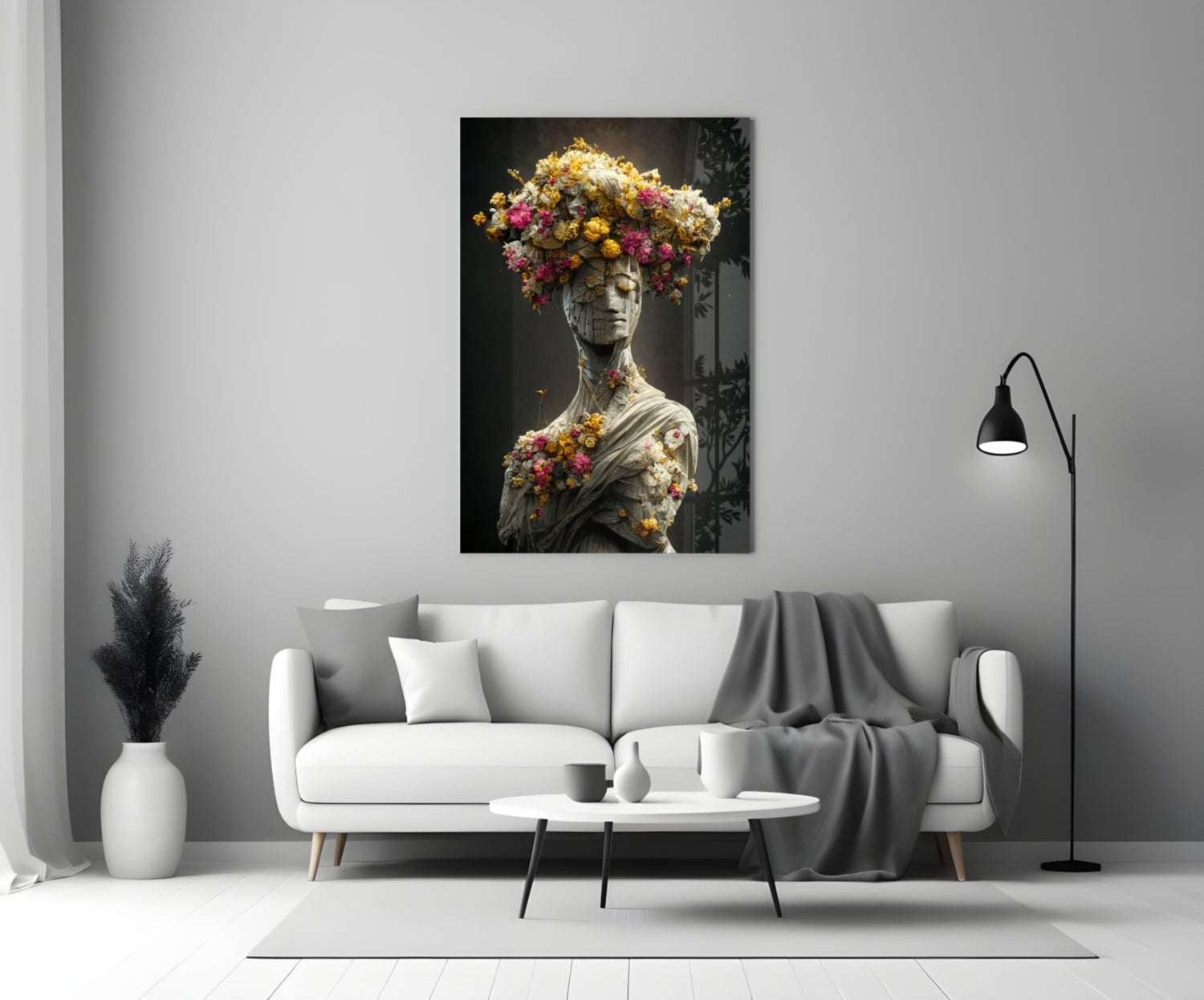 Classical stone bust adorned with vibrant yellow, pink, and white flowers displayed above white sofa in modern living room.