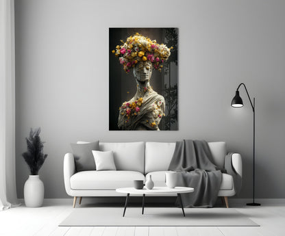 Classical stone bust adorned with vibrant yellow, pink, and white flowers displayed above white sofa in modern living room.