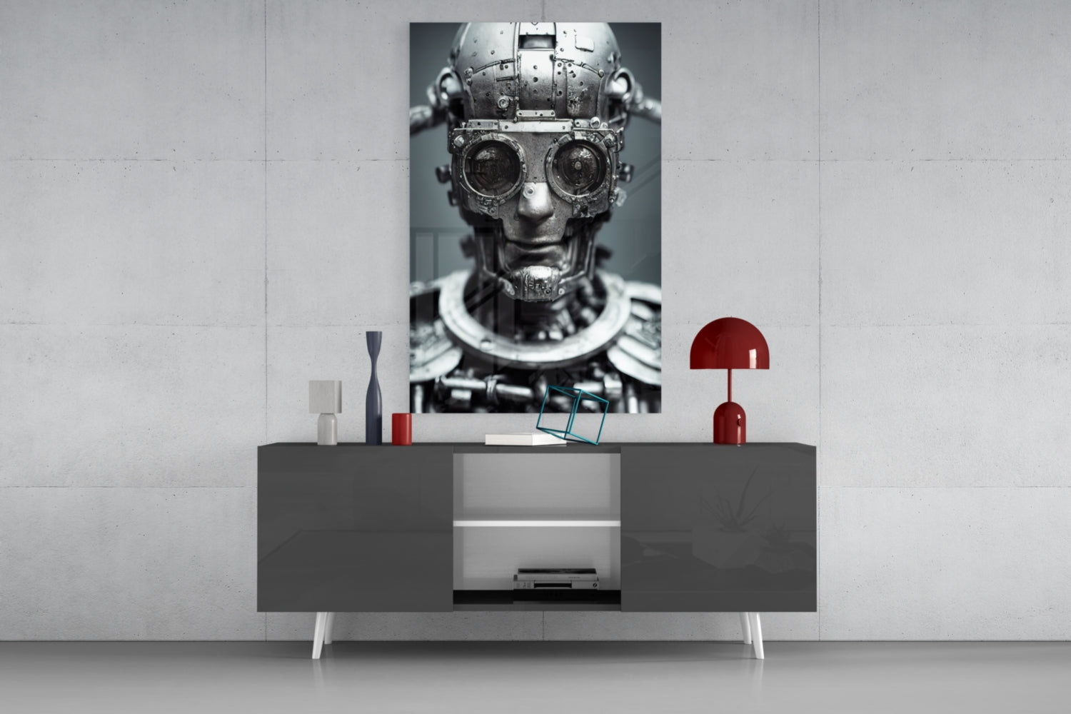 Monochrome mechanical robot head with circular lens eyes displayed on a dark console shelf with red decorative accessories and white wall background.