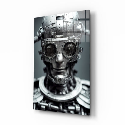 Metallic humanoid head with mechanical camera lenses for eyes on grayscale glass wall art, angled three-quarter view.