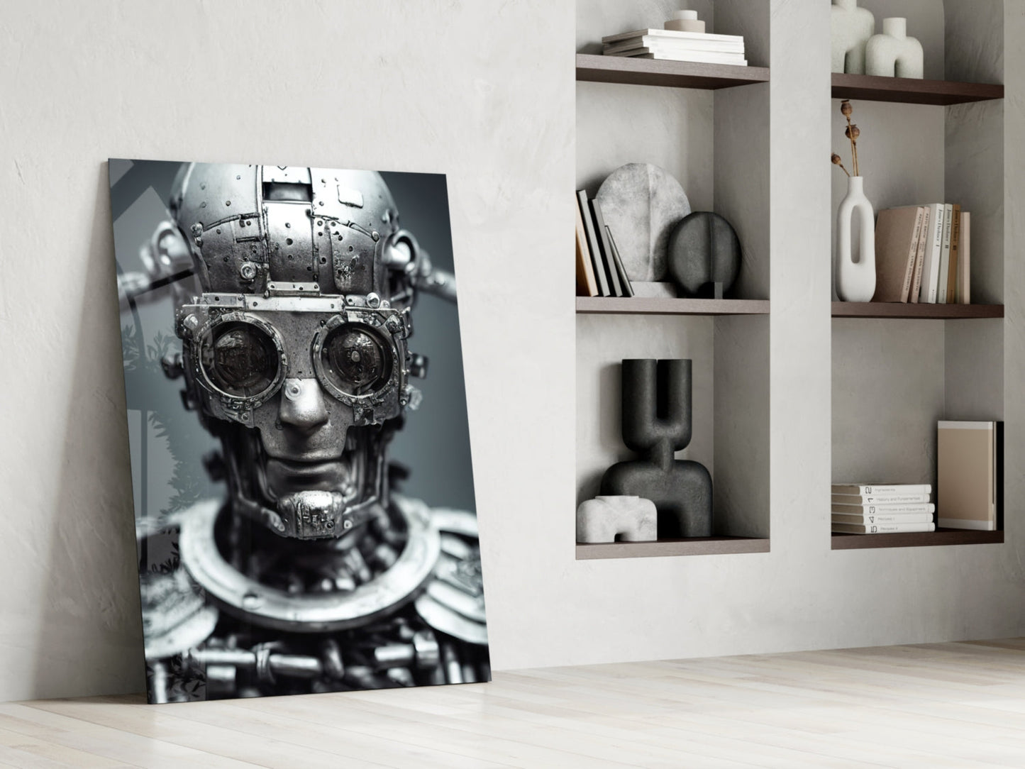 Monochromatic mechanical skull artwork leaning against white wall beside shelving unit displaying decorative objects and books.