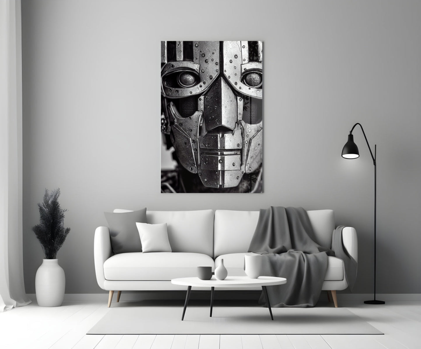 Black and white metallic robot head artwork displayed above white sofa in minimalist living room setting.