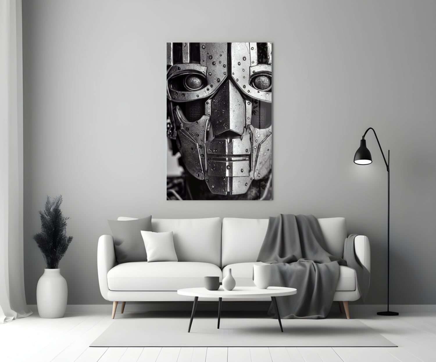 Black and white metallic robot head artwork displayed above white sofa in minimalist living room setting.