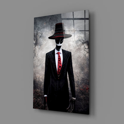 Angled view of glass art panel featuring silhouetted figure in black suit and red tie wearing wide-brimmed hat against bare tree background.