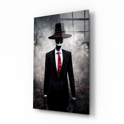 A faceless figure in a black suit and red tie wears a wide-brimmed black hat, standing against a desolate forest backdrop on glass art.
