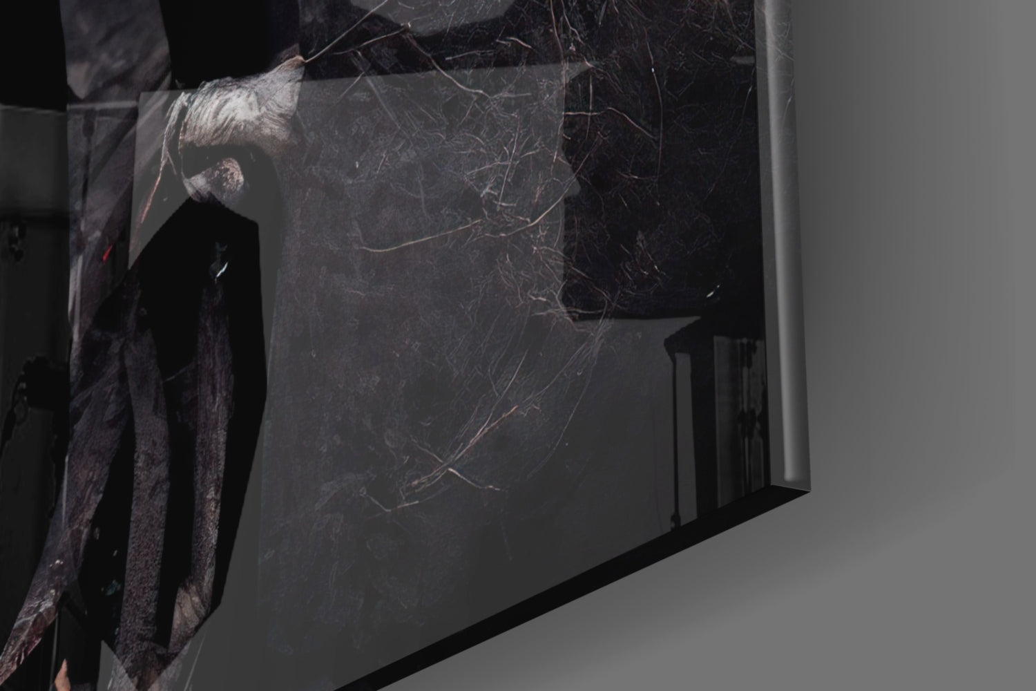 Dark textured glass panel with etched linear patterns, displayed at an angle in gallery setting with dramatic lighting and shadow.